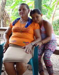 Doña Adilia outside her home with one of her granddaughters